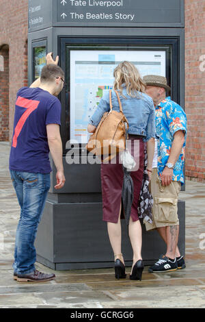 Tourists looking at information maps, in Liverpool, Merseyside, UK Stock Photo