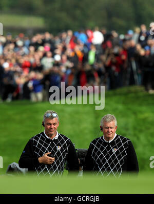 European captain Colin Montgomerie (right) and vice captain Darren Clarke during the afternoon foursomes during the Ryder Cup at Celtic Manor, Newport. Stock Photo
