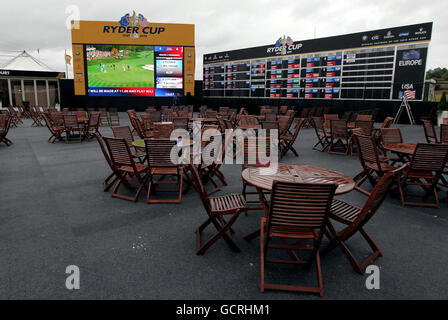 Big screens play to empty public areas in the tented village while the public are not permitted into the course as the start of play is delayed during the Ryder Cup at Celtic Manor, Newport. Stock Photo