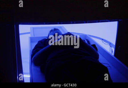 A visitor entering 'Bindu Shards, 2010' - a sealed chamber with coloured lighting - during a private preview of an exhibition of work by American artist James Turrell, at the Gagosian Gallery in central London. Stock Photo