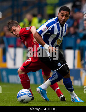 Sheffield Wednesday's Jon Otsemobor and Leyton Orient's Dean Cox (left) battle for the ball during the npower League One match at Hillsborough, Sheffield. Stock Photo