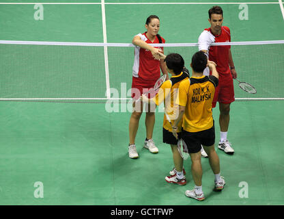 England's Nathan Robertson and Jenny Wallwork (above left) shake hands after losing against Malaysia's Kien Koo and Ee Chin in the mixed doubles final of the badminton competition during Day Eleven of the 2010 Commonwealth Games at the Siri Fort Sports Complex in New Delhi, India. Stock Photo