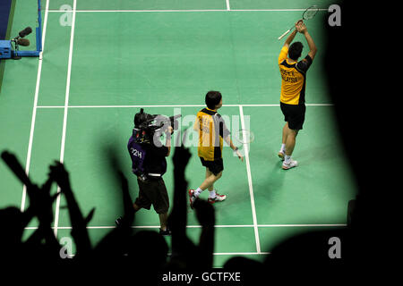 Fans cheer as Malaysia's Kien Koo and Ee Chin celebrate their victory over England's Nathan Robertson and Jenny Wallwork in the mixed doubles final of the badminton competition on day eleven of the 2010 Commonwealth Games at the Siri Fort Sports Complex in Delhi, India Stock Photo