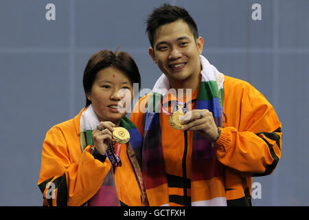 Malaysia's Kien Koo and Ee Chin celebrate with their gold medals after defeating England's Nathan Robertson and Jenny Wallwork in the mixed doubles final of the badminton competition on day eleven of the 2010 Commonwealth Games at the Siri Fort Sports Complex in Delhi, India Stock Photo