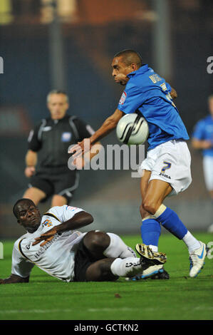 Port Vale's Anthony Griffith (left) slides in to challenge and Shrewsbury Town's Mark Wright Stock Photo