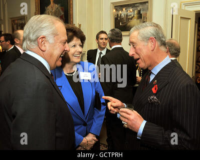 The Prince of Wales talks to Lord and Lady Guthrie, during a reception for supporters of the Welsh Guards Afghanistan appeal, at Clarence House in central London. Stock Photo
