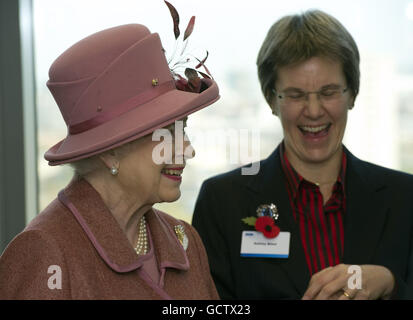 Queen Elizabeth II talks to staff members during a visit to mark the official opening of the new KPMG building at Canada Square in London's Docklands. Stock Photo