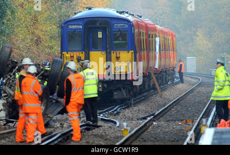 General view of a lorry laying on the train track close to Oxshott station after it crashed through a wall on the overhead bridge and landed on top of a train yesterday. Stock Photo