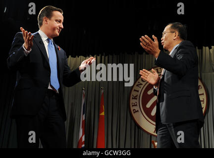 Prime Minister David Cameron and Executive Vice President and Provost Professor Lin Jianhua (right) speak to students at Peking University in Beijing on the second of a two day trip to China. Stock Photo