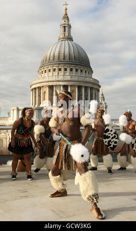 A group of Zulu warriors from the Mighty Zulu Nation Theatre Company are seen infront of St Paul's Cathedral as they perform a traditonal Zulu welcome for the new Lord Mayor of the City of London Michael Bear (not pictured) on the rooftop of the One New Change shopping centre, in central London. Stock Photo