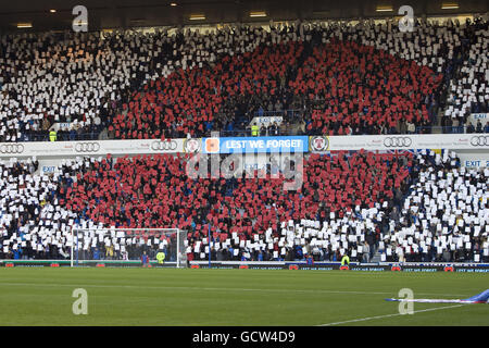 SPECIAL PICTURE - RELEASED EXCLUSIVELY THROUGH THE PRESS ASSOCIATION FOR USE BY NATIONAL AND REGIONAL NEWSPAPERS - UK & IRELAND ONLY. NO SALES. Rangers' fans in the hold up cards at the start of the match in the shape of a poppy Stock Photo