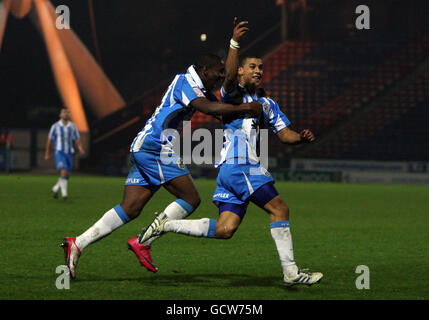 Huddersfield Town's Lee Peltier (right) celebrates scoring his sides first goal during the first round replay match at the Galpharm Stadium, Huddersfield. Stock Photo