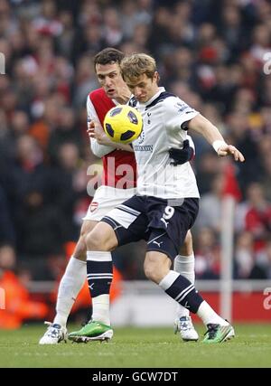 Arsenal's Sebastien Squillaci (left) and Tottenham Hotspur's Roman Pavlyuchenko (right) battle for the ball Stock Photo