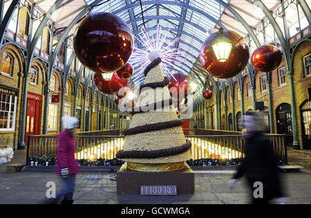 A giant Ferrero edible Christmas Tree is set up in Covent Garden, central London, to mark a month until Christmas day. Stock Photo