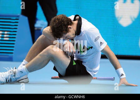 Great Britain's Andy Murray reacts after slipping as he competes against Spain's Rafael Nadal during day seven of the Barclays ATP World Tennis Tour Finals at the O2 Arena, London. Stock Photo