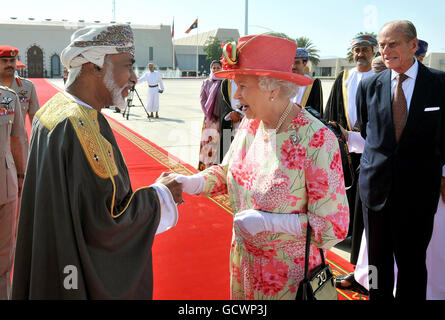 Queen Elizabeth II shakes hands with the Sultan of Oman, His Majesty Sultan Qaboos bin Said, before she and the Duke of Edinburgh (right) depart Muscat Airport for home, after a five day State Visit to the Gulf region. Stock Photo