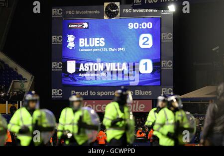 Soccer - Carling Cup - Quarter Final - Birmingham City v Aston Villa - St Andrews' Stadium. General view of the final score on the scoreboard as riot Police line up on the pitch after Birmingham City fans invade the pitch