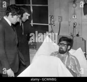 Stewart MacMillan of Denny, injured in the Ibrox Park disaster, talks to Rangers' players, Sandy Jardine, left, and John Greig, who visited his bedside at the Victoria Infirmary. Stock Photo