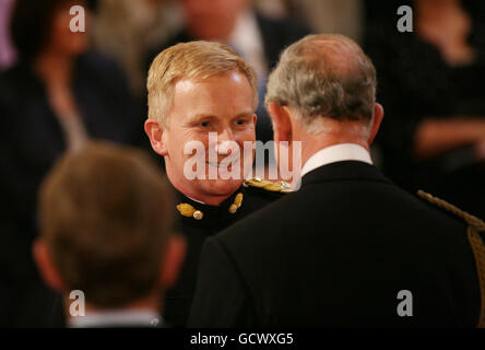 Lieutenant Colonel Nicholas Lock of The Royal Welsh, is made an Officer of the British Empre (OBE) by the Prince of Wales at an investiture ceremony at Buckingham Palace, London. Stock Photo