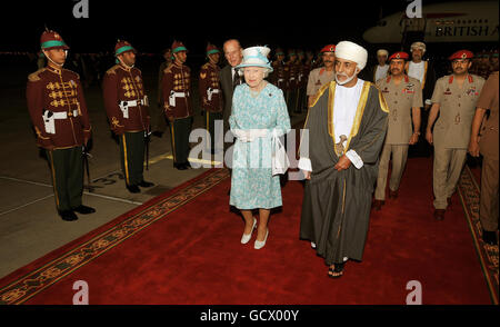 Queen Elizabeth II walks with the Sultan of Oman, His Majesty Sultan Qaboos bin Said, after arriving in Oman from the United Arab Emirates. Stock Photo