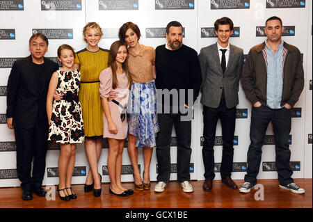 (L-R) Novelist Kazuo Ishiguro, actresses Isobel Meikle Small, Carey Mulligan, Ella Purnell and Keira Knightley, director Mark Romanek, actor Andrew Garfield and screenwriter Alex Garland seen at a photocall for new film Never Let Me Go at the Vue cinema in London. PRESS ASSOCIATION photo. Picture date: Wednesday 13th October 2010. Photo credit should read: Ian West/PA Stock Photo