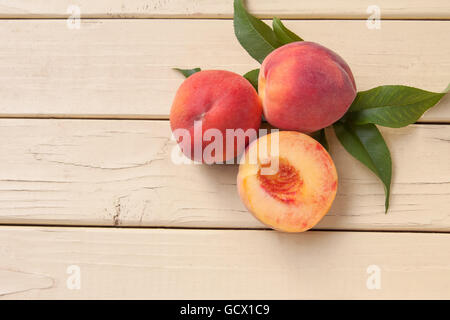 Freshly picked organic peaches with leaves from tree - top view Stock Photo