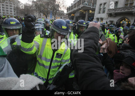 Police and students clash as they protest against a planned rise in university tuition fees in central London. Stock Photo