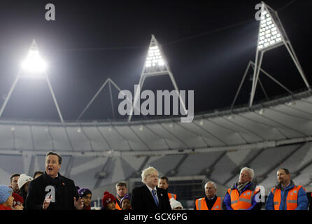 The Olympic Stadium floodlights are officially switched on by Prime Minister David Cameron at the Olympic Park in Stratford, London. Stock Photo