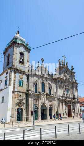 People in front of principal facade of igreja dos Carmelitas church and Carmo church in Porto, Stock Photo