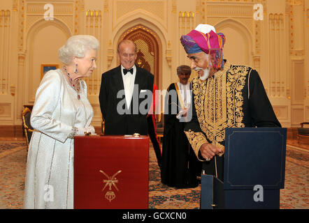 Queen Elizabeth II waits with anticipation before the Sultan of Oman, His Majesty Sultan Qaboos bin Said presents her with a gold musical Faberge style egg, before a State Banquet at his Palace in Muscat, Oman. Stock Photo