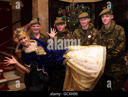 Anita Dobson who plays Carabosse is lifted up by (from left), Cpl Stuart Wedge, Pte Sean Bruce, Pte Robert Shaw, and Pte Joshua Morris who serve in the Argyll and Sutherland Highlanders 5th Battalion based at Canterbury, Kent. The Prime Minister's wife Samantha Cameron met the families of the soldiers before a special performance of the pantomime, Sleeping Beauty at the Richmond Theatre for the charity Tickets For Troops. Stock Photo