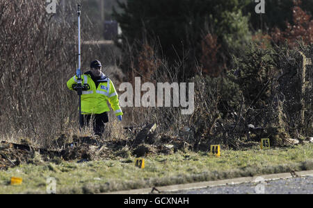 Gardai at the scene on the southbound lane of the M1 near Milltown, Co Louth, where two people were killed after a single car ploughed through a fence early this morning. Stock Photo