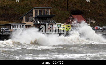 Waves break over the North Bay Drive at Scarborough today as the winter weather returns to the UK with snow, ice and strong winds sweeping into the east coast. Stock Photo