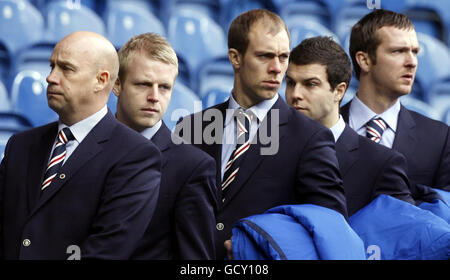 Rangers' ( left to right) Kenny McDowall (1st team Coach) and players Steven Naismith, Steven Whittaker, Richard Foster and Andy Webster arrive for the memorial service to commemorate the 40th anniversary of the Ibrox Disaster at the Ibrox stadium in Glasgow . Stock Photo