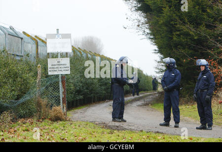 Specialist prison officers line the perimeter fence to HMP Ford near Arundel, West Sussex after about 40 prisoners began a riot and set alight the open prison, according to the Ministry of Justice. Stock Photo