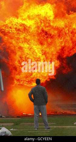 An inmate watches as a fireball consume an accommodation block at HMP Ford near Arundel, West Sussex, after about 40 prisoners began a riot and set alight buildings in the open prison, according to the Ministry of Justice. Stock Photo