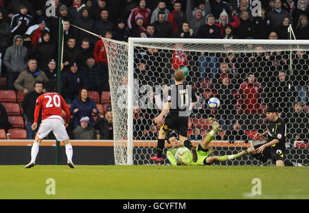 Stoke City's Sanli Tuncay's (left) see his shot cleared off the line by Cardiff City's Paul Quinn (right) during the FA Cup Third round match at the Britannia Stadium, Stoke. Stock Photo