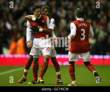 Arsenal's Robin van Persie (left) celebrates scoring his side's first goal of the game with teammates Alex Song (17) and Bacary Sagna (right) Stock Photo