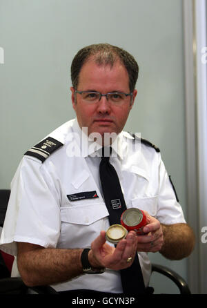 Assistant Director of UK Border Agency Grant Miller demonstrates devices used to drug traffic at Heathrow Airport. Stock Photo