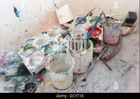 discarded left behind dirty paint brushes in butlers sink needing a serious clean and polish after messy art students painters Stock Photo