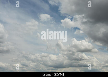 skyscape of dramatic puffy cotton wool clouds of layered cumulus stratocumulus developing into cumulonimbus higher altostratus Stock Photo