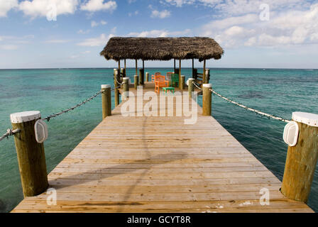 Wooden pier at Hotel Compass Point Resort at Love beach Nassau, Bahamas, Caribbean. Brightly Colored Cottages At Compass Point B Stock Photo