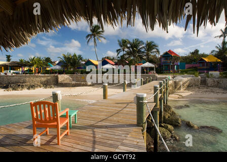 Wooden pier at Hotel Compass Point Resort at Love beach Nassau, Bahamas, Caribbean. Brightly Colored Cottages At Compass Point B Stock Photo