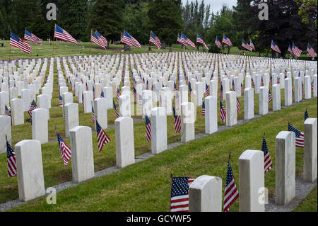 Memorial Day Ceremony at cemetery with American Flags at grave sites Stock Photo