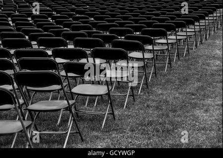 Rows of empty seats before a memorial day service Stock Photo