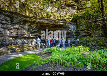 People on guided tour of Jack Daniel's Distillery grounds' location site of Cave Spring water in Lynchburg, TN Stock Photo