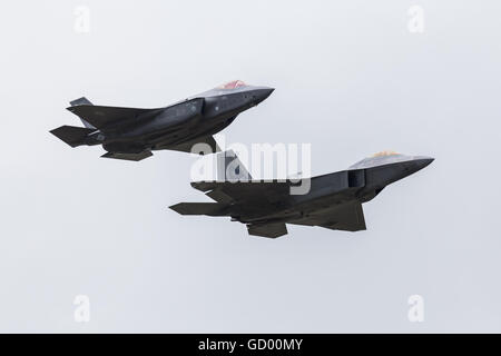 F-35A Lightning II performs a flypast with an F-22A Raptor in the USAF Heritage Flight pictured at the RIAT 2016. Stock Photo