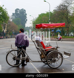 Bicycle taxi and rider Hanoi, Vietnam Stock Photo