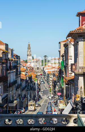 Tram crossing Rua 31 de Janeiro street with Igreja and tower dos Clerigos in background. Porto. Portugal. Stock Photo