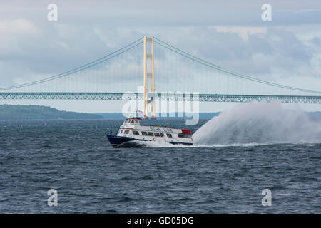 Michigan, Lake Michigan. Star Line Ferry in front of Mackinac Bridge (aka Big Mac or Mighty Mac). Stock Photo